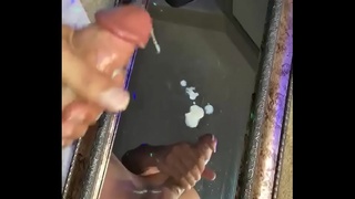 Moaning while he blows a huge cumshot on a mirror